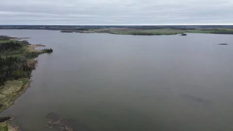 Aerial drone pull-back from a river cape on a moody, overcast day. Stock Footage 312416756