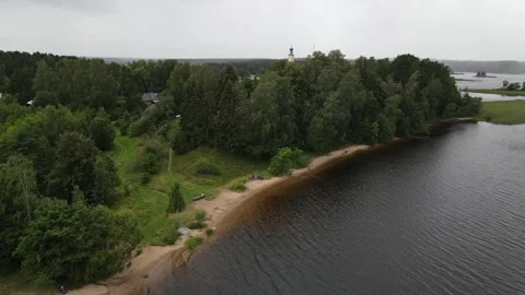 Aerial drone pull-back shot over Lake Seliger with historic church Stock Footage 338095570