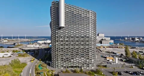 Aerial drone pull back shot of Amager Bakke Copenhill waste to energy plant.. Stock Footage 339640513