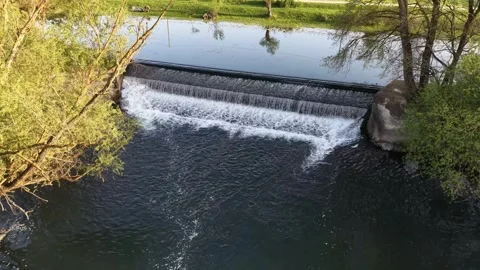 Aerial Drone Pull Back from Small Dam Waterfall on River Video stock 332990735