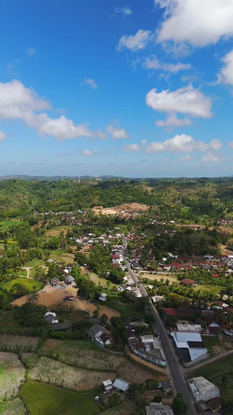 Aerial drone pull back vertical over Sade village Lombok Indonesia lush green Stock Footage 346611350