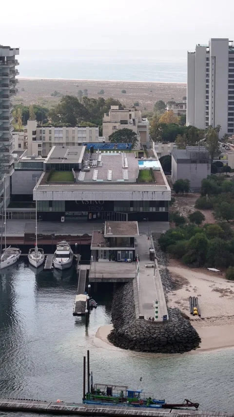Aerial drone pull back view of marina and casino in Troia, Portugal Stock Footage 319452016
