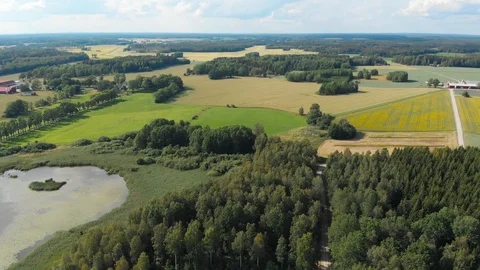 Aerial drone pull down scenery landscape agricultural fields shadow and light Video stock 114035657