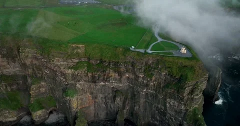Aerial drone pullback and ascent revealing O'Brien's Tower on Cliffs of Moher Stock Footage 339503832
