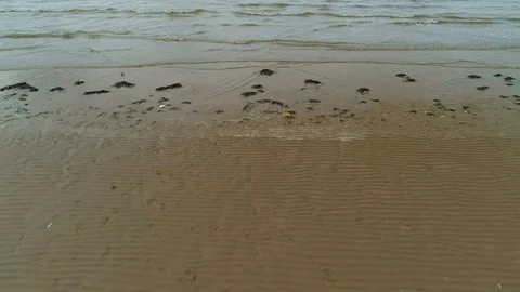 Aerial drone pullback of Antony Gormley sculpture on beach Stock Footage 111574138