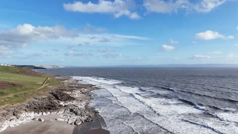 Aerial Drone Pullback Over Rocky Green Coast and Sea, Wales UK 4K Stock-Footage 334066875