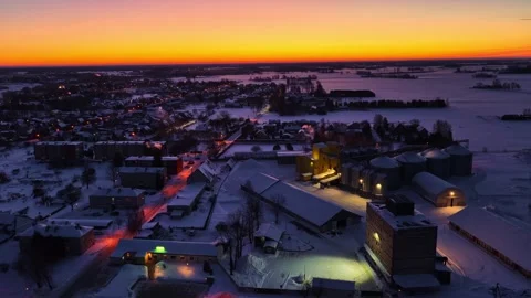 Aerial Drone Pullback Over Snow-Covered Latvian Town with Industrial Silos at Stock-Footage 333327458