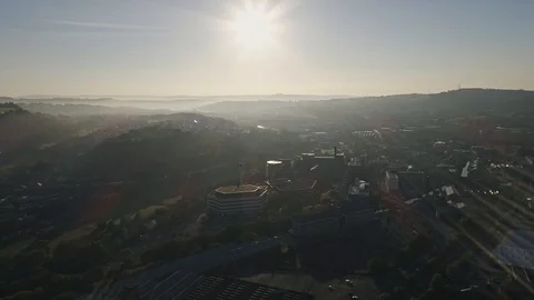 Aerial drone pullback to reveal town of Saltaire mist at sunrise Stock Footage 110823738