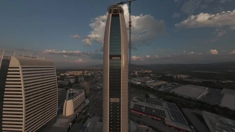 Aerial drone pullback revealing modern skyscraper at sunset in Sofia, Bulgaria. Stock Footage 340270216