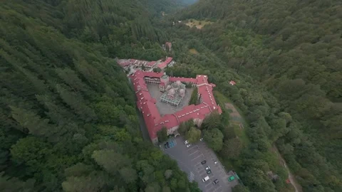 Aerial drone pullback revealing Rila Monastery and forest valley in Bulgaria. Stock Footage 341469741