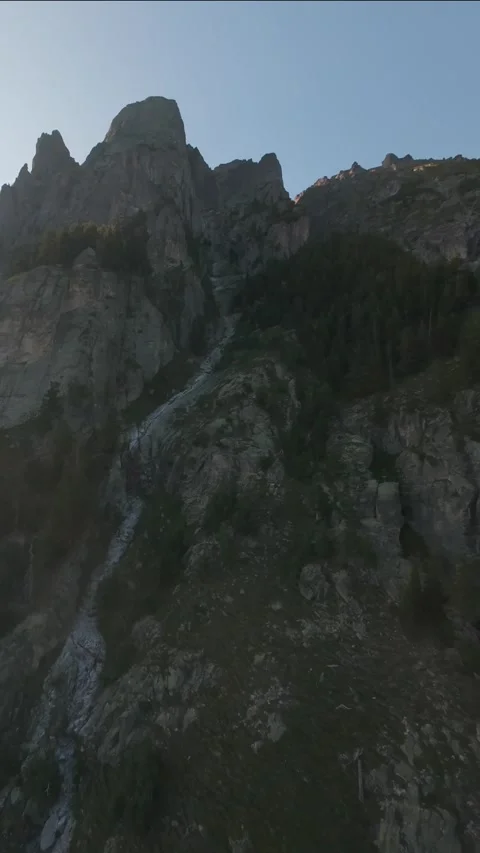 Aerial drone pullback revealing rocky mountain peaks at sunset in Rila, Bulgaria Stock Footage 343419126