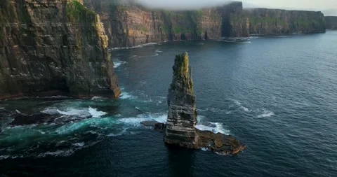Aerial drone pullback from sea stack at Cliffs of Moher along Atlantic Stock Footage 339504531