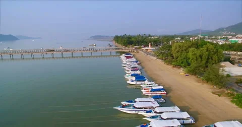 Aerial Drone Pullback Shot Over Speedboats On Tropical Beach Video stock 63401355