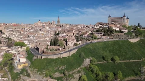 Aerial drone pullback from Toledo skyline with Alcazar and Cathedral Stock Footage 331731140