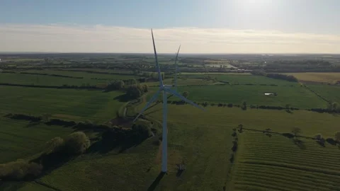 Aerial Drone Pullback from Wind Turbine in Green Countryside Stock Footage 333937035