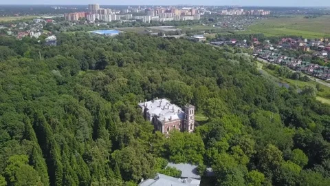 Aerial drone pulling back above manor and forest Stock Footage 325624721