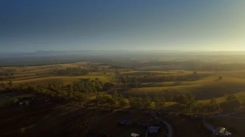 Aerial drone pulling back rolling hills at sunrise, in the Hunter Valley Stock Footage 104895322