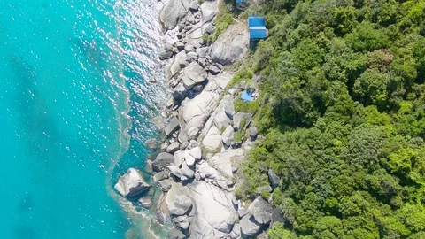 Aerial Drone Pulling Up Overhead on Rocks by Haad Rin Beach Koh Phangan Thailand Stock Footage 97659668