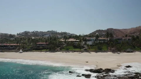 Aerial drone pulls away from resort coastline in Cabo San Lucas. Stock Footage 134596370