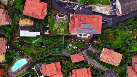 Aerial Drone Push Down Over Italian Village Rooftops Revealing Garden Patio Stock Footage 336709469
