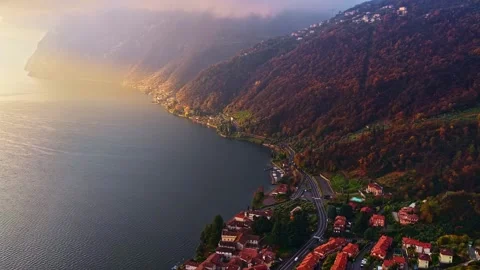 Aerial Drone Push Forward Over Lake Iseo Shoreline With Autumn Mountains at Stock-Footage 336959538