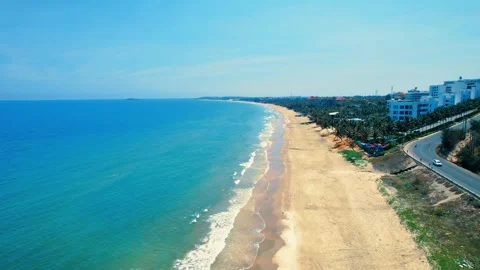 Aerial drone push over an empty pristine summer beach with blue ocean 4K Stock Footage 338370168