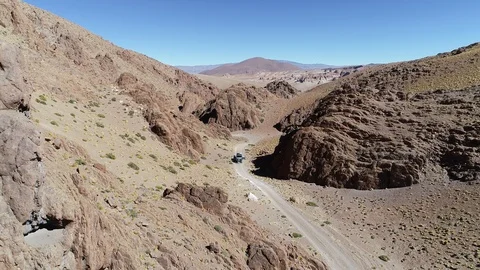 Aerial drone scene of 4x4 van at off road in a narrow red canyon 스톡 동영상 103449751