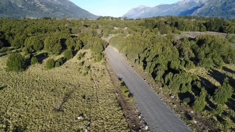 Aerial drone Scene, Camera moving backward throw a dirt road Stock Footage