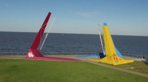 Aerial drone scene flying in between colorful wind sculptures Vídeo Stock 68300233