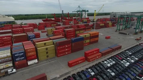 Aerial drone scene flying over container in an import export harbor while people Vídeo Stock 60051174