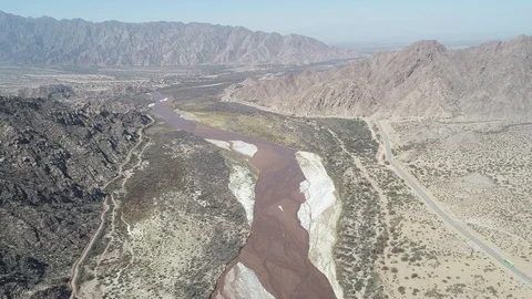 Aerial drone scene with general view of rocky mountains and wide Fiambala river 스톡 동영상 96228740