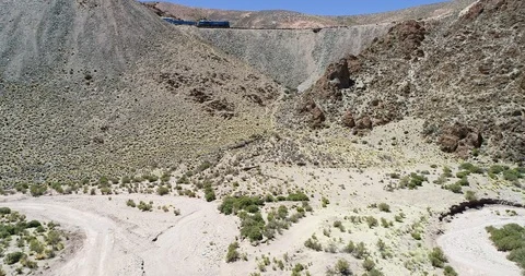 Aerial drone scene of train driving through desertic mountain 스톡 동영상 126604546