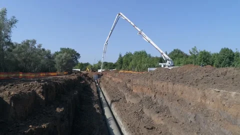 Aerial drone shot above constructions site outdoor. Big white crane pouring Stock Footage 131012725