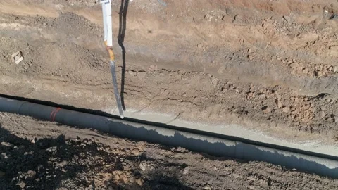 Aerial drone shot above constructions site outdoor. Big white crane pouring Stock Footage 131015730