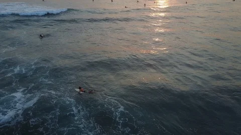 Aerial Drone Shot Berawa Beach in Canggu Bali at Sunset with Surfers Stock Footage 101784331