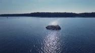 Aerial Drone Shot Of Birds On A Rock At Sea Who Suddenly Start To Fly Away Stock Footage