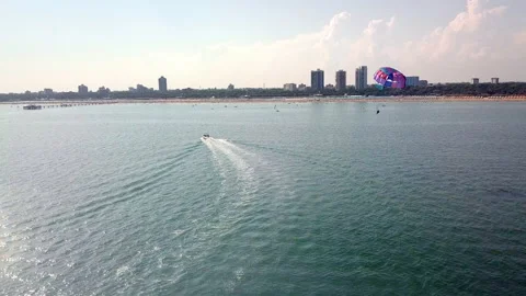 Aerial drone shot of boat pulling parachute over the sea in lignano parasailing Stock-Footage 233645784