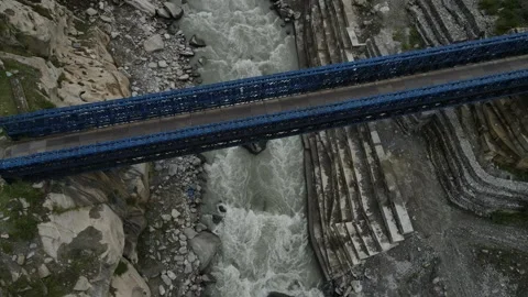 Aerial Drone Shot of a bridge above the flowing river Stock Footage 274110448