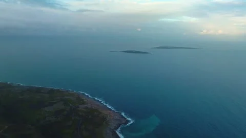 Aerial drone shot captures rocky shoreline of Cape Zemlyanov as it meets the vas Stock Footage 308934076