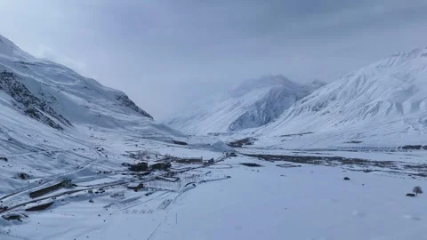 Aerial drone shot capturing the breathtaking view of snow-covered Kaza, the Stock Footage 304942599