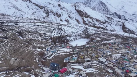 Aerial drone shot capturing the breathtaking view of frozen Nako Lake during Stock Footage 304959313