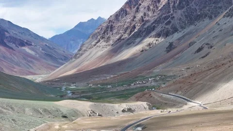 Aerial drone shot capturing the contrast of a single car on a straight road in Video stock 310751652