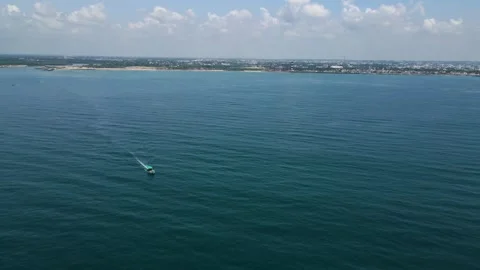 Aerial drone shot capturing the delicate balance of a fisher boat on the gentle Stock Footage 297596737