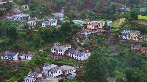 Aerial drone shot capturing early morning light over a quiet mountain village. Stock Footage 310748586
