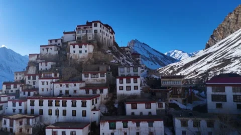 Aerial drone shot capturing the last rays of sunlight touching the snow-covered Stock Footage 304953607