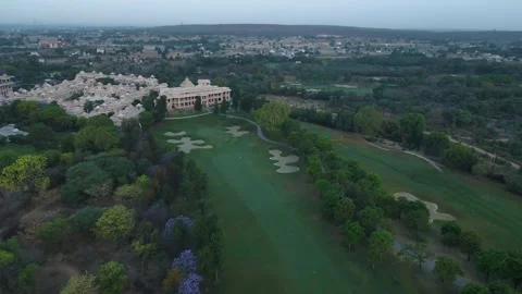 Aerial drone shot capturing the lush green expanse of a golf club in Delhi, with Stock Footage 305829776