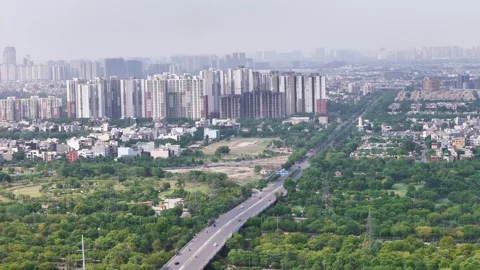 Aerial drone shot capturing Noida’s skyline with modern high-rise buildings and Stock Footage 312486539