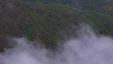 Aerial drone shot capturing a quiet, cloud-blanketed morning in the highlands. Stock Footage 310748283