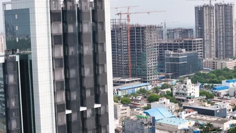 Aerial drone shot capturing reflections of the sky and cityscape on the facade Stock Footage 312488523