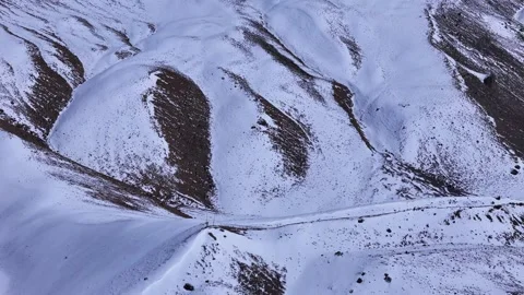 Aerial drone shot capturing the sense of adventure as a white car follows a road Stock Footage 304956652